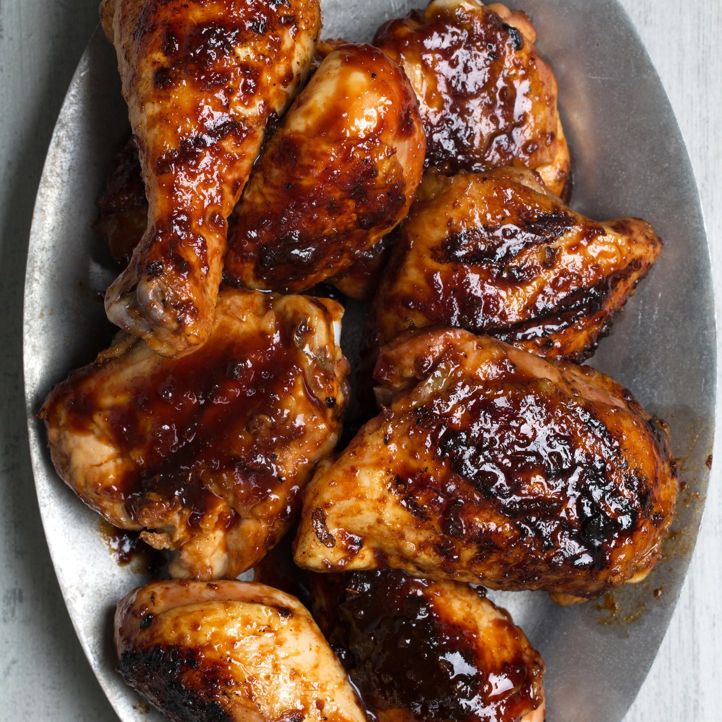 Grilled chicken leg quarters with sweet and sour sauce